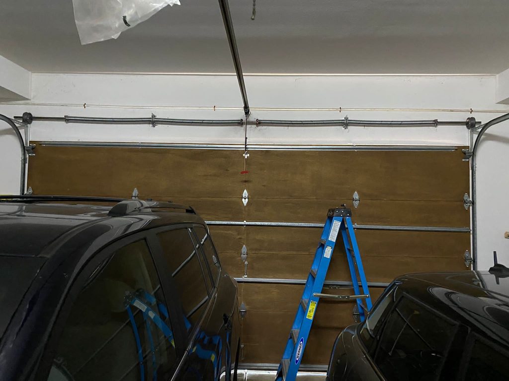 Old red LiftMaster garage door opener before replacement