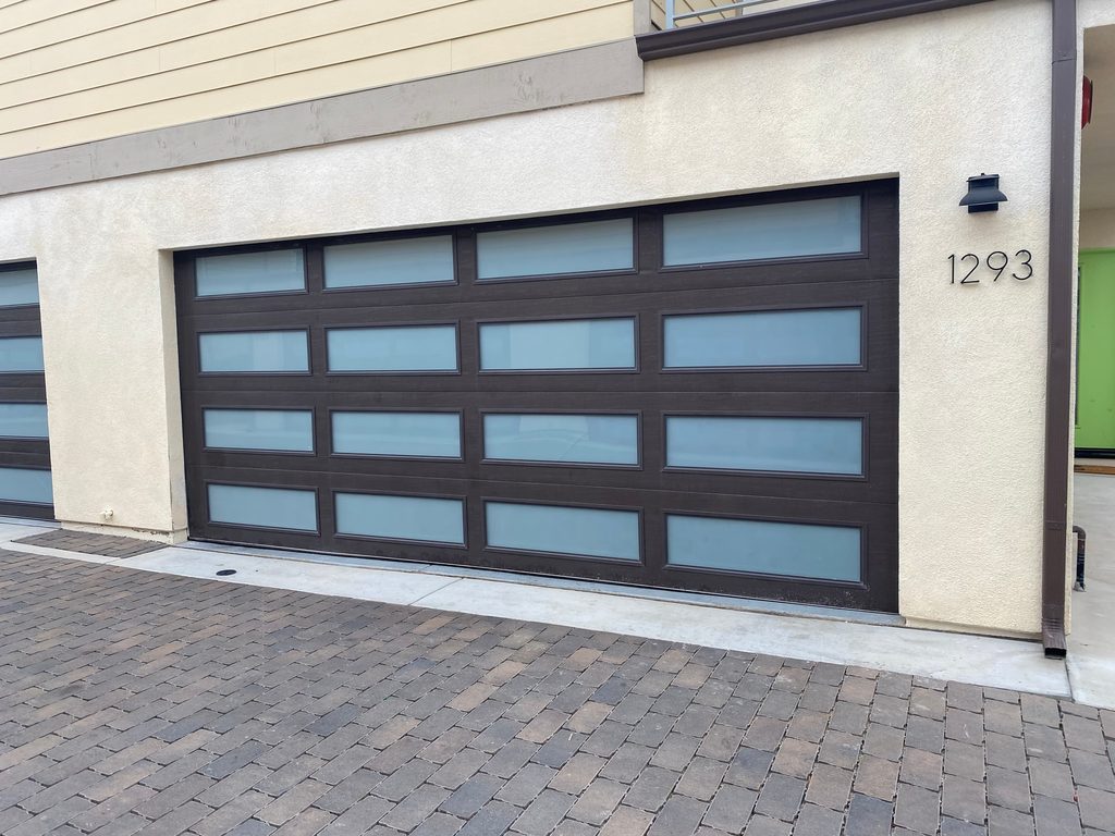 Brown carriage-style garage door with arched windows, Chula Vista