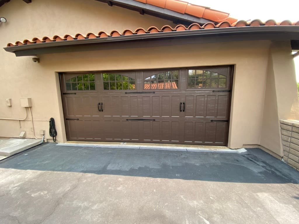 Brown carriage-style garage door with arched windows, El Cajon