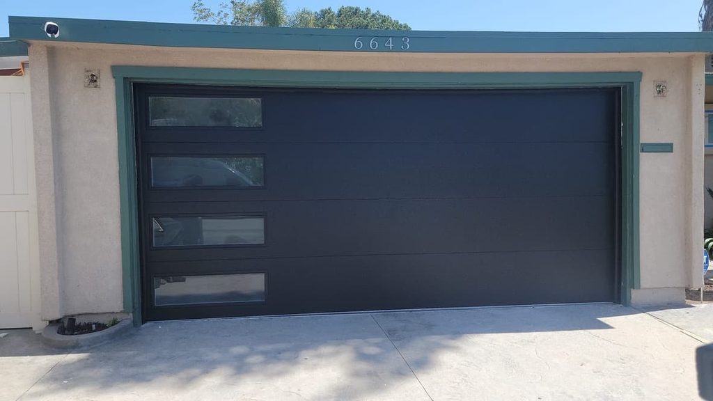 Brown carriage-style garage door with arched windows, Tierrasanta