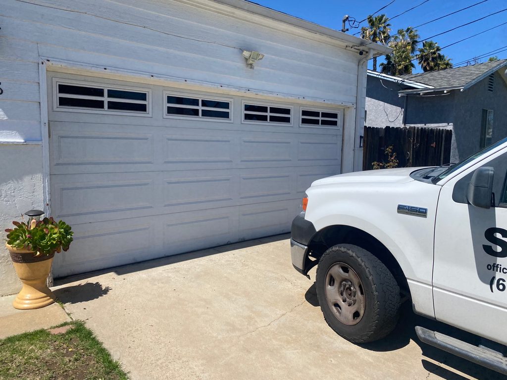Dark gray modern flush garage door with side windows, Ocean Beach