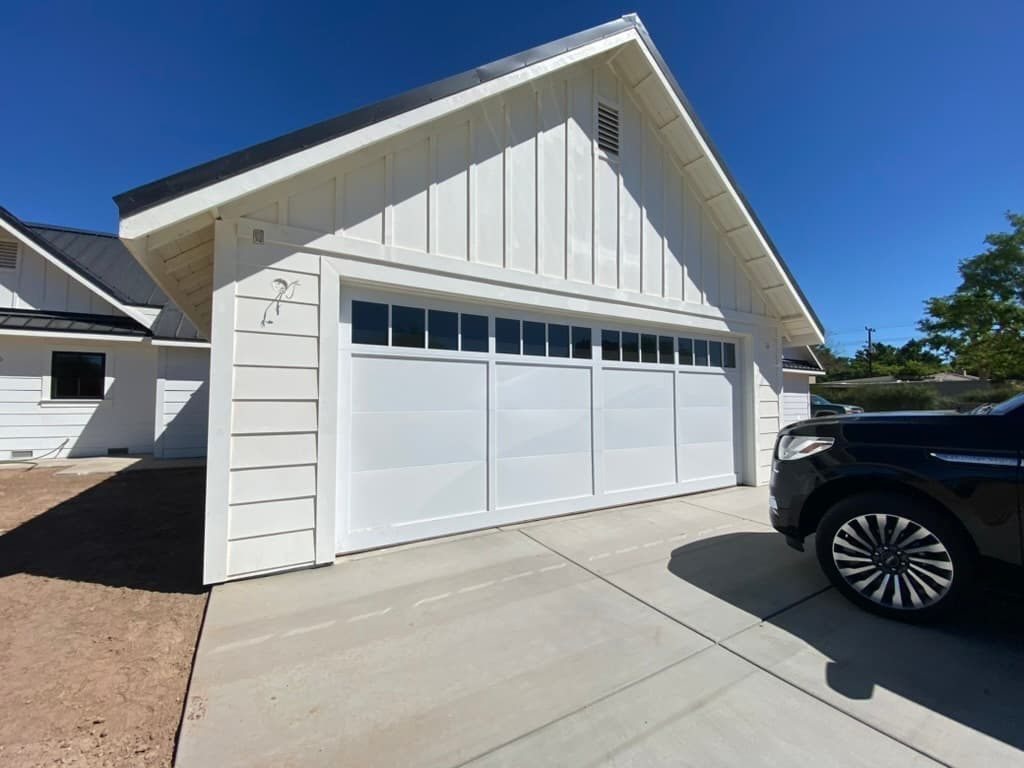 Dark walnut long-panel garage door with windows, Mira Mesa