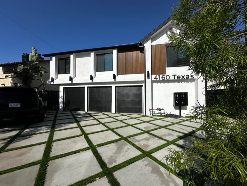 Three black flush garage doors on a modern home, North Park