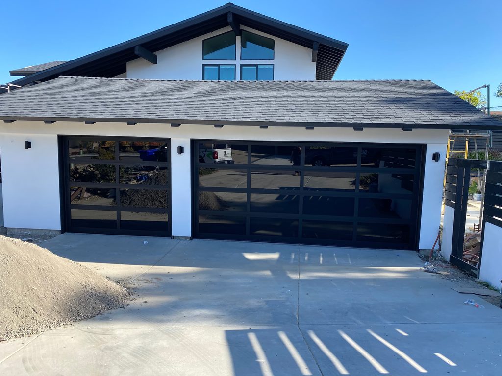 Two black full-view glass garage doors on a new build, La Jolla